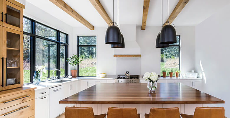 A kitchen with wooden cabinets and a dining room table