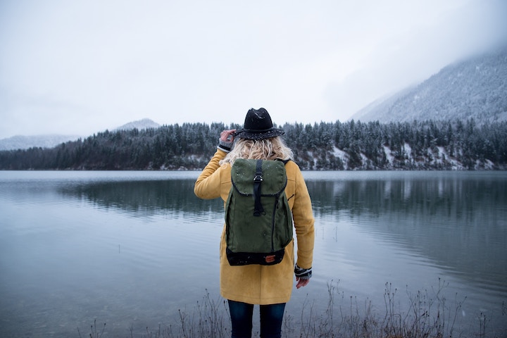A person standing next to a lake