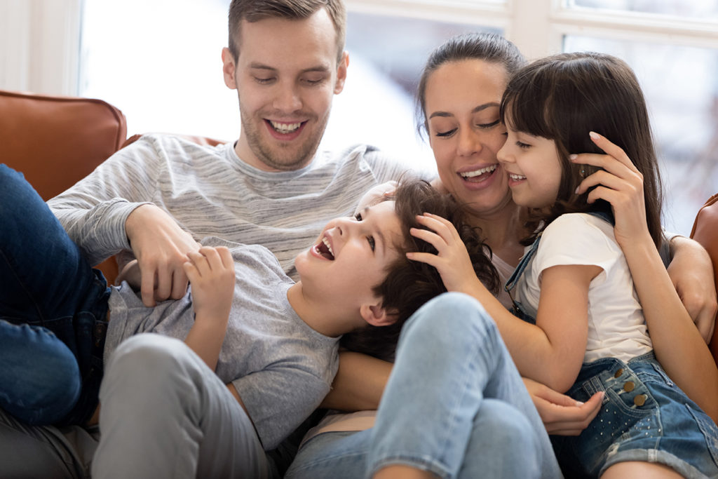 family sitting on sofa