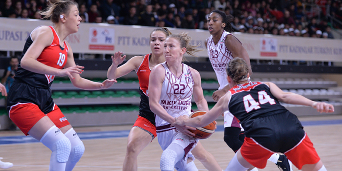 A group of people playing basketball